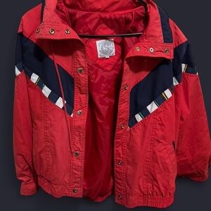 Red and navy vintage 80s bomber jacket with zipper and button closure